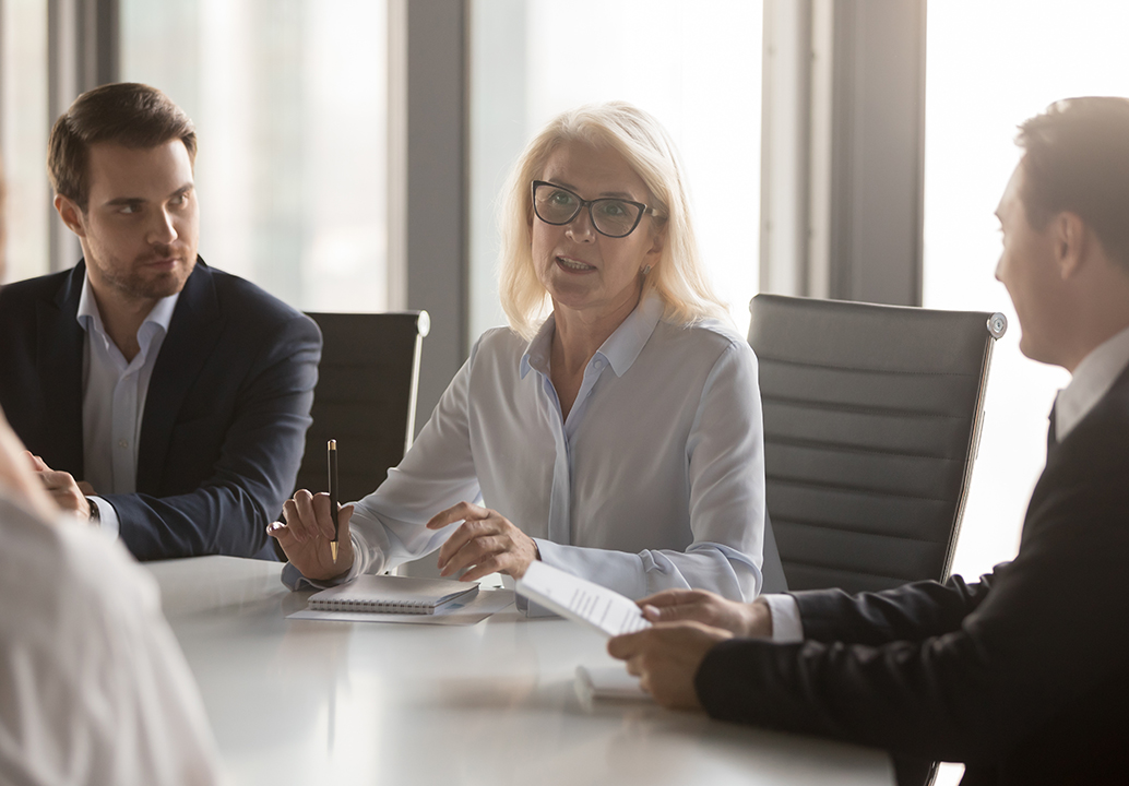 middle aged businesswoman leading a meeting